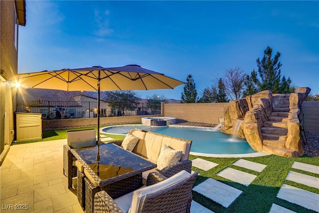 view of pool with a patio, a fenced backyard, and a pool with connected hot tub