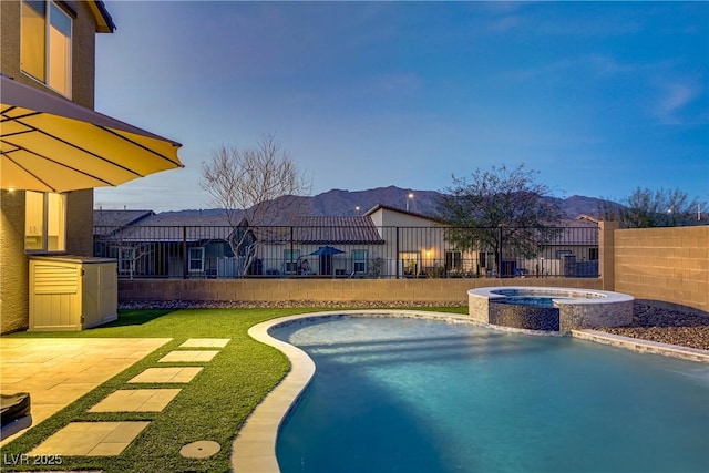 view of swimming pool featuring a fenced in pool, a patio area, fence, and an in ground hot tub