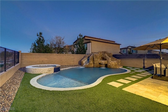 view of swimming pool with a pool with connected hot tub and a fenced backyard