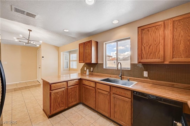 kitchen with visible vents, a peninsula, a sink, light countertops, and dishwasher