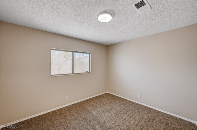 carpeted empty room featuring visible vents, baseboards, and a textured ceiling