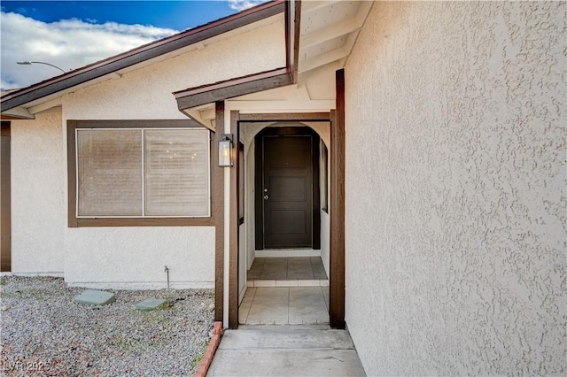 doorway to property with stucco siding