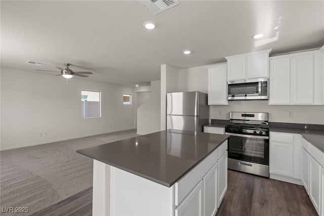 kitchen featuring dark countertops, visible vents, appliances with stainless steel finishes, and open floor plan