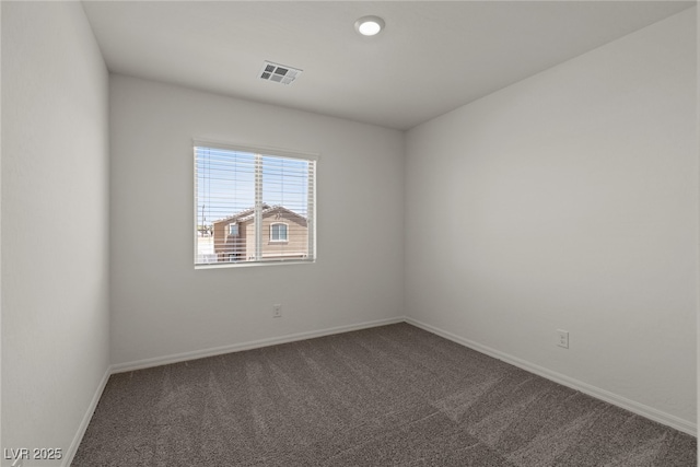 unfurnished room with carpet, visible vents, and baseboards