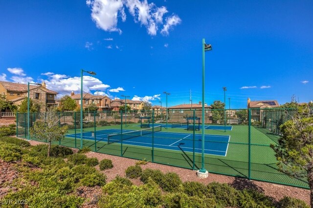 view of sport court featuring a residential view and fence