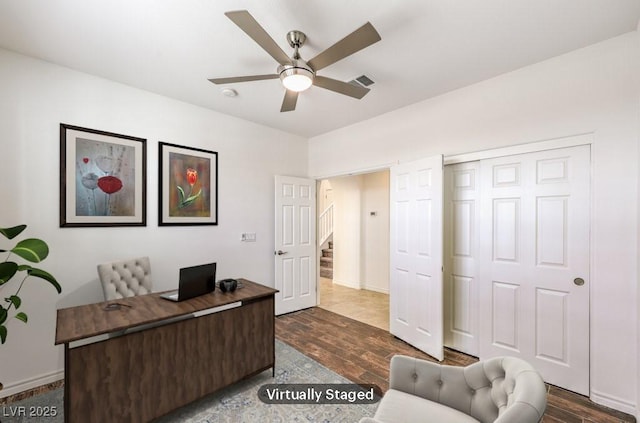 home office with baseboards, dark wood finished floors, visible vents, and a ceiling fan