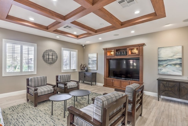 living room with light wood-style flooring, coffered ceiling, visible vents, and baseboards