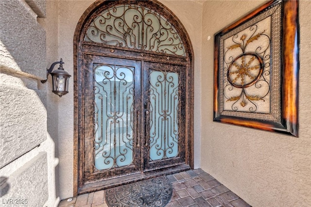 doorway to property with stucco siding