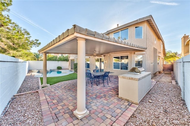 view of patio featuring a fenced backyard, ceiling fan, a fenced in pool, and area for grilling