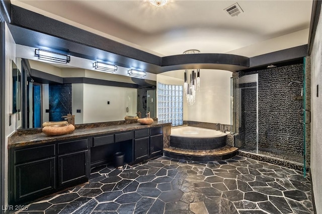 bathroom with double vanity, a garden tub, a shower stall, and visible vents