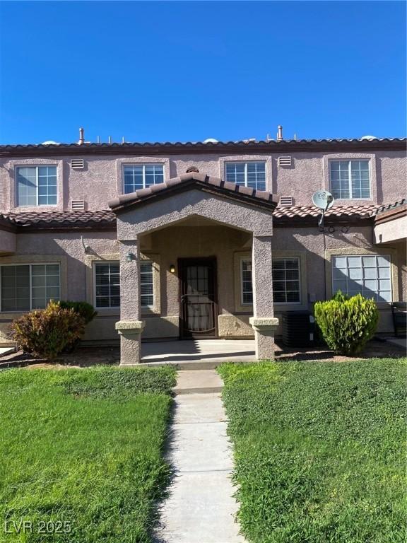 view of front of home featuring a tile roof and stucco siding