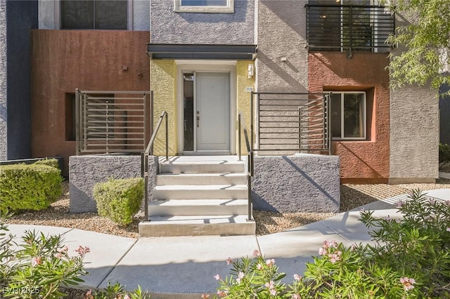 entrance to property with stucco siding