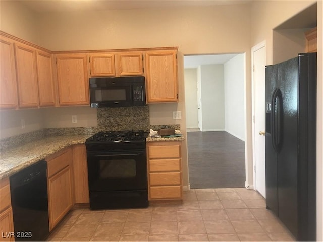 kitchen featuring light tile patterned floors and black appliances