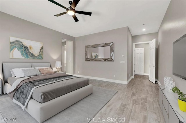 bedroom with light wood-style floors, ceiling fan, and baseboards