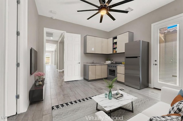 kitchen featuring light wood-style flooring, visible vents, appliances with stainless steel finishes, and open shelves