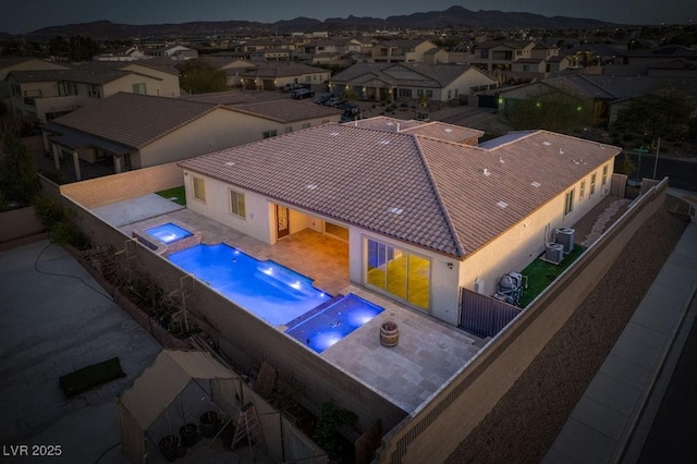 view of pool featuring a fenced backyard, an in ground hot tub, a residential view, a fenced in pool, and a patio area