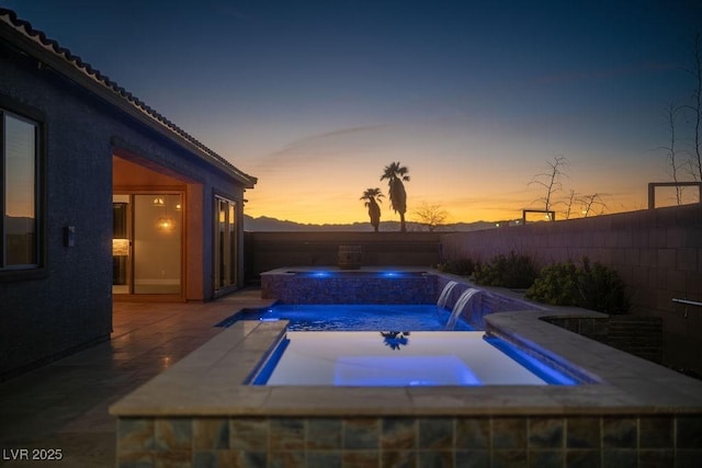 view of pool with a patio area, a fenced backyard, a fenced in pool, and an in ground hot tub