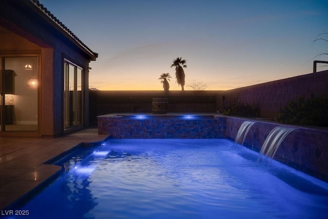 view of pool with a pool with connected hot tub and a patio area