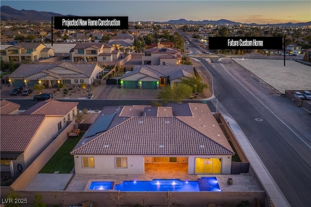 aerial view at dusk with a residential view and a mountain view