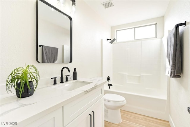 bathroom featuring shower / bathtub combination, toilet, wood finished floors, vanity, and visible vents