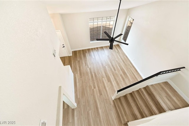 stairway with baseboards and wood finished floors