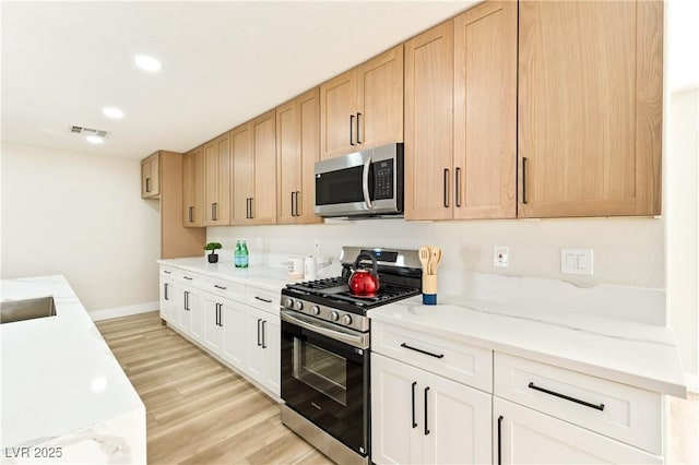 kitchen featuring recessed lighting, visible vents, baseboards, appliances with stainless steel finishes, and light wood-type flooring