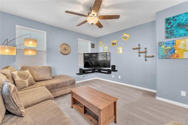 living room featuring ceiling fan, carpet floors, and baseboards