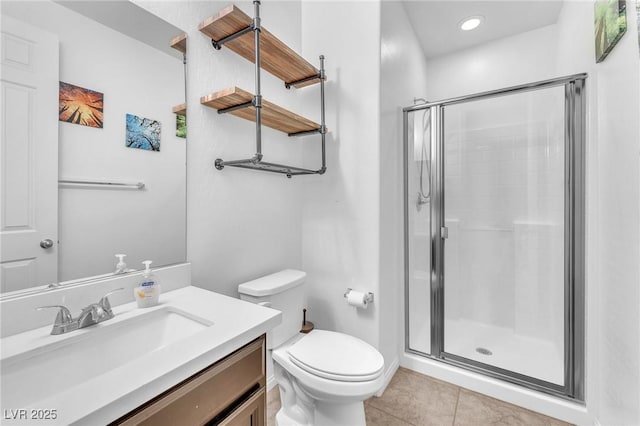 full bathroom featuring toilet, a stall shower, tile patterned flooring, and vanity