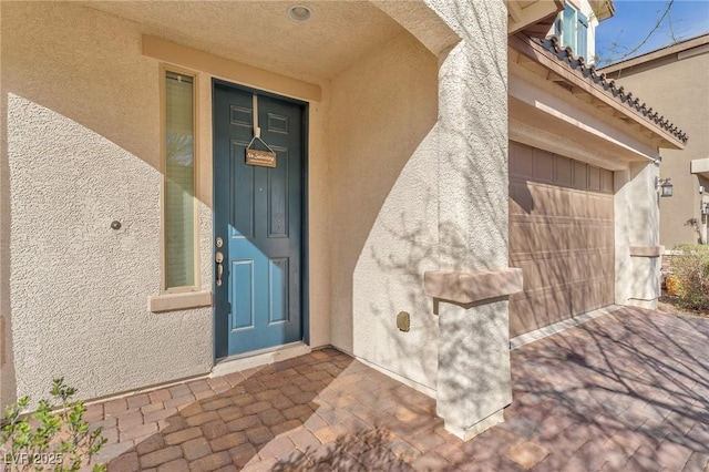 view of exterior entry featuring stucco siding