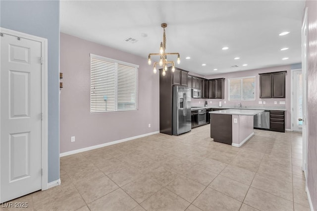 kitchen with stainless steel appliances, light countertops, visible vents, dark brown cabinetry, and baseboards