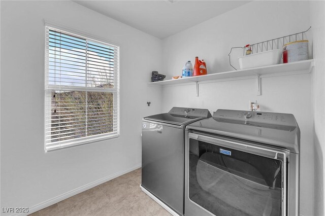 laundry room with washer and dryer, laundry area, baseboards, and light tile patterned floors