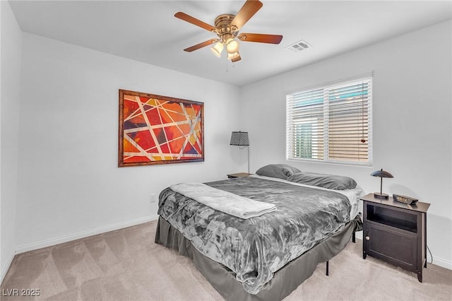 bedroom featuring a ceiling fan, light colored carpet, visible vents, and baseboards