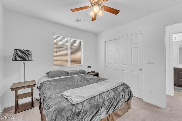 bedroom featuring light carpet, baseboards, visible vents, ceiling fan, and a closet