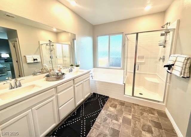 full bathroom with double vanity, a bath, a stall shower, and a sink