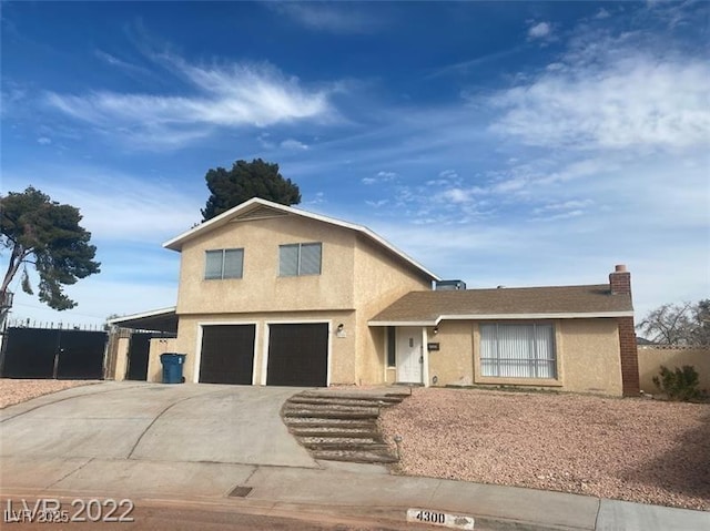 view of front of property featuring concrete driveway, an attached garage, and stucco siding