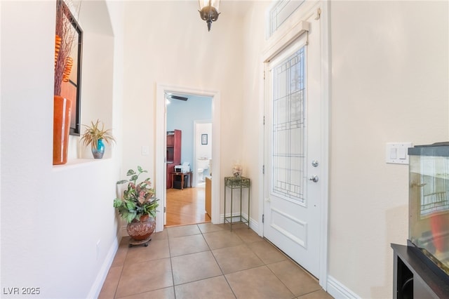 interior space featuring light tile patterned floors and baseboards