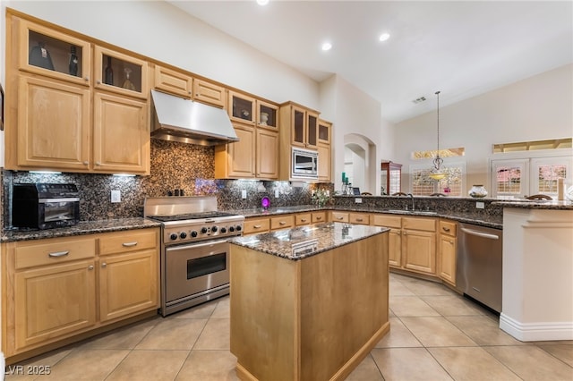 kitchen featuring a peninsula, appliances with stainless steel finishes, range hood, and light tile patterned flooring