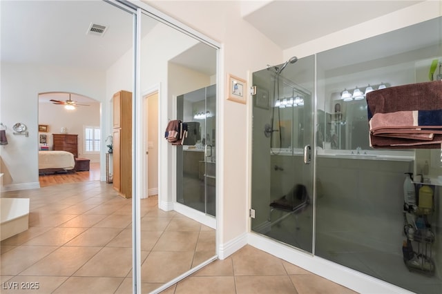 full bath featuring tile patterned flooring, visible vents, connected bathroom, ceiling fan, and a stall shower