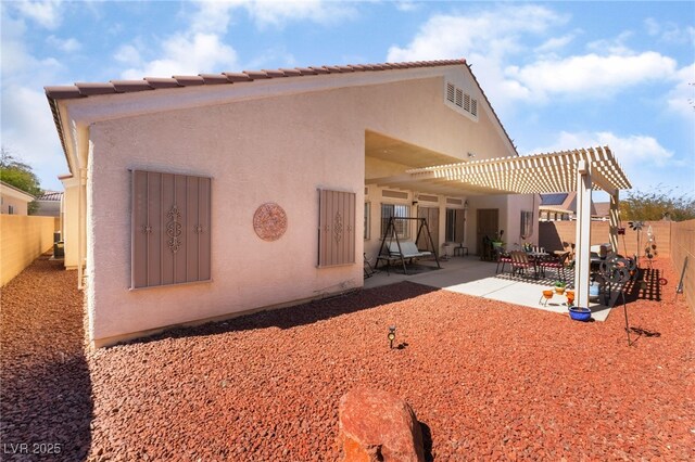 back of property featuring a patio, a fenced backyard, a pergola, and stucco siding