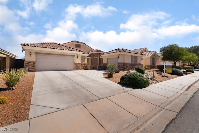 mediterranean / spanish home with stone siding, stucco siding, an attached garage, and driveway