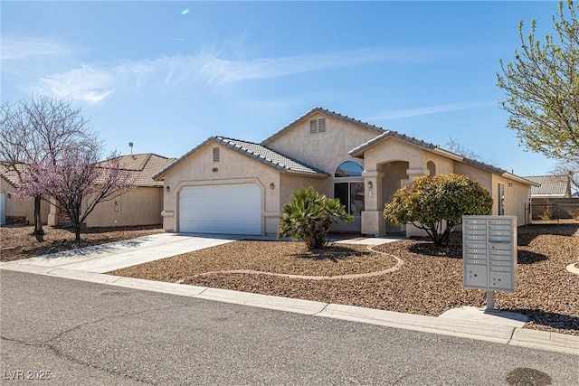 mediterranean / spanish-style home with driveway, a garage, and stucco siding