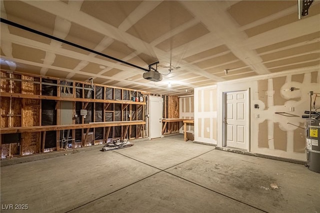 garage with electric water heater and a garage door opener