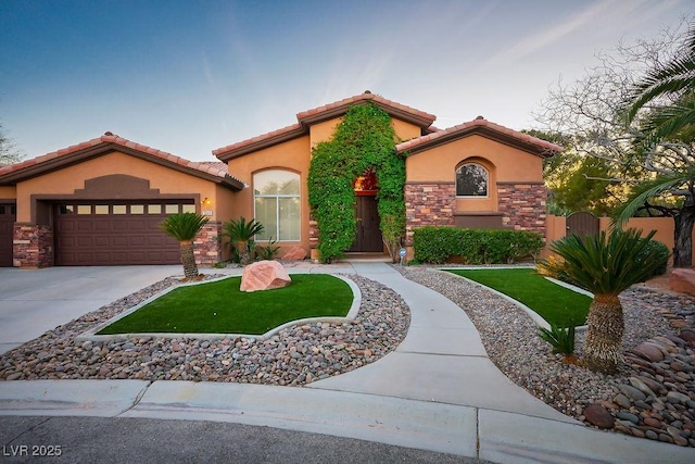 mediterranean / spanish-style home featuring driveway, stucco siding, a garage, stone siding, and a tiled roof