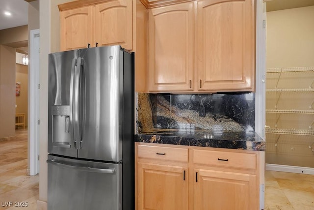 kitchen featuring tile countertops, light brown cabinets, tasteful backsplash, and stainless steel refrigerator with ice dispenser