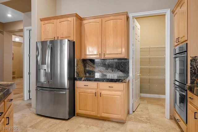 kitchen with decorative backsplash, tile counters, light brown cabinetry, and stainless steel appliances