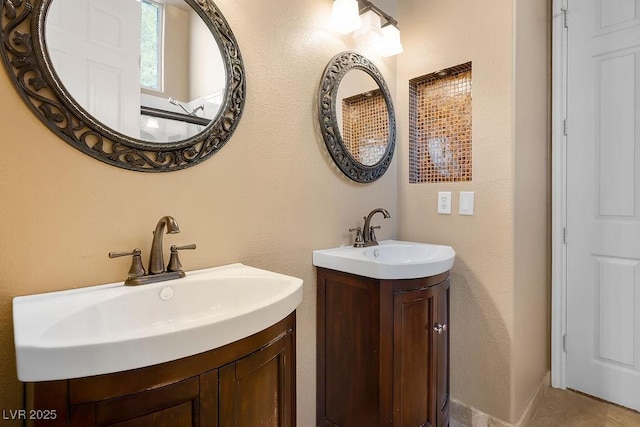 bathroom with a sink and two vanities