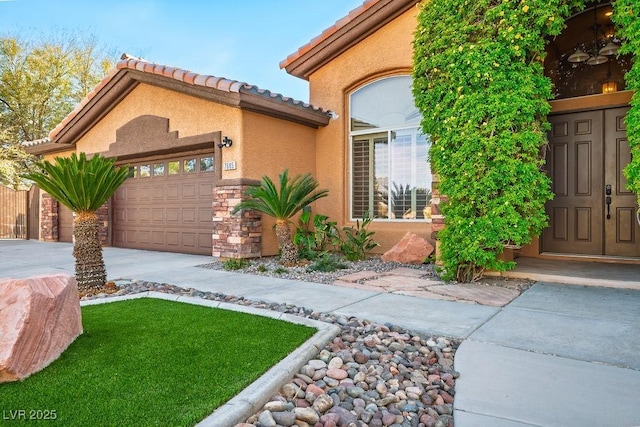 view of front facade with driveway, an attached garage, stucco siding, stone siding, and a tiled roof