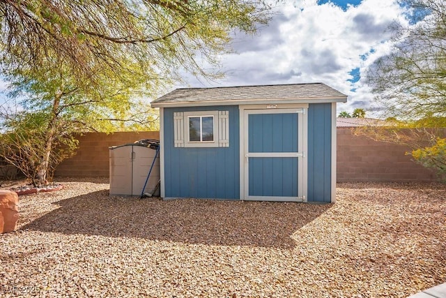 view of shed with a fenced backyard