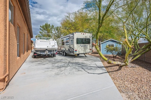 view of vehicle parking with a storage unit