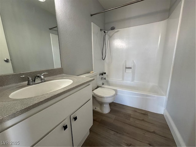 bathroom featuring tub / shower combination, vanity, toilet, and wood finished floors